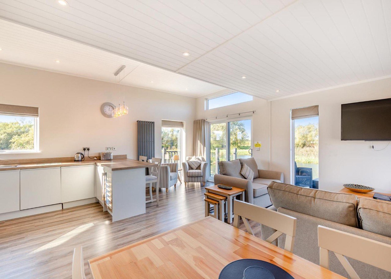 Bright open plan interior with lake views through patio doors